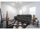 Bright living room featuring a gray reclining sofa, stylish patterned rug, and modern decor at 7853 Summerlake Groves St, Winter Garden, FL 34787