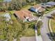 Aerial view of an elegant home with a tile roof, paver driveway and manicured landscaping at 8064 Peaceful Cir, Sanford, FL 32771