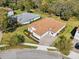 Aerial view of a home with a tile roof, paver driveway and manicured landscaping at 8064 Peaceful Cir, Sanford, FL 32771