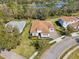 Aerial view of an elegant home with a three-car garage, paver driveway and manicured landscaping at 8064 Peaceful Cir, Sanford, FL 32771