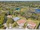 Aerial view of home with a tile roof, manicured lawn, and close proximity to a lake at 8064 Peaceful Cir, Sanford, FL 32771