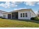 Beautiful home featuring a screen enclosed patio, manicured lawn, and a stucco exterior at 8064 Peaceful Cir, Sanford, FL 32771
