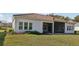 Beautiful home featuring a screen enclosed patio, manicured lawn, and a stucco exterior at 8064 Peaceful Cir, Sanford, FL 32771