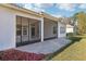 Beautiful backyard with a paved patio, screened lanai and lush landscaping, perfect for outdoor enjoyment at 8064 Peaceful Cir, Sanford, FL 32771