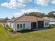 Aerial of a backyard with manicured lawn, garden, screened patio and tile roof at 8064 Peaceful Cir, Sanford, FL 32771