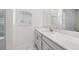 Bright bathroom with white cabinets, mirror, and modern fixtures at 8064 Peaceful Cir, Sanford, FL 32771