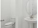Bathroom features a modern sink and toilet with crisp white paint at 8064 Peaceful Cir, Sanford, FL 32771