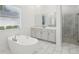 Bright bathroom featuring a standalone tub and separate glass-enclosed shower at 8064 Peaceful Cir, Sanford, FL 32771