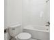Bathroom features a shower over tub and white tiling at 8064 Peaceful Cir, Sanford, FL 32771
