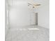 Bright bedroom featuring marble floors, a modern ceiling fan, and an open doorway at 8064 Peaceful Cir, Sanford, FL 32771