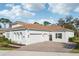 Lovely single-story home featuring a terracotta roof, large garage, and paved driveway at 8064 Peaceful Cir, Sanford, FL 32771