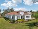 Elegant home with lush landscaping, paver driveway, and arched entryway at 8064 Peaceful Cir, Sanford, FL 32771