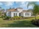 Charming single-story home featuring a terracotta roof, stucco facade, and lush landscaping at 8064 Peaceful Cir, Sanford, FL 32771