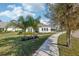 Charming home with lush landscaping, mature trees, and a terracotta tile roof at 8064 Peaceful Cir, Sanford, FL 32771
