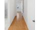 Bright hallway features beautiful hardwood floors leading to various rooms at 8064 Peaceful Cir, Sanford, FL 32771