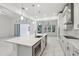 Bright kitchen features a large island with a stainless steel sink and open layout leading to the living area at 8064 Peaceful Cir, Sanford, FL 32771