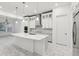 Bright kitchen features white cabinets, stainless steel appliances, and a large center island with pendant lighting at 8064 Peaceful Cir, Sanford, FL 32771