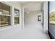 Bright, large lanai with tile floor and views of the surrounding landscape through multiple windows at 8064 Peaceful Cir, Sanford, FL 32771