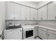 Well-equipped laundry room with modern washer, dryer, and ample cabinet space at 8064 Peaceful Cir, Sanford, FL 32771