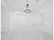 Open living room with marble floors and a modern chandelier at 8064 Peaceful Cir, Sanford, FL 32771