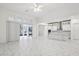 Open living space with white marble tile, leading into the kitchen and outdoor patio at 8064 Peaceful Cir, Sanford, FL 32771