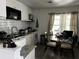 Eat-in kitchen with white cabinets, subway tile backsplash and a round glass dining table at 914 2Nd St, Orlando, FL 32824