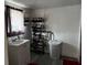 Laundry room with a white utility sink, shoe rack and a white plastic hamper at 914 2Nd St, Orlando, FL 32824