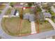 Aerial view of the house with a large yard surrounded by green trees, with a red boundary line at 1012 E De Carlo Dr, Deltona, FL 32725