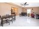 Open-concept living room with modern ceiling fan, neutral walls, and white marbled-tile flooring at 1012 E De Carlo Dr, Deltona, FL 32725