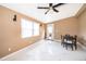 Bright living room featuring neutral walls, ceiling fan, white marbled-tile flooring, and lots of natural light at 1012 E De Carlo Dr, Deltona, FL 32725