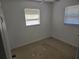 Bright bedroom with natural light from two windows, featuring neutral walls and flooring at 1130 E Bay St, Winter Garden, FL 34787