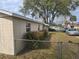 View of home's side exterior featuring a chain link fence and partial landscaping at 1130 E Bay St, Winter Garden, FL 34787