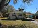 Cozy single-story home with a carport and mature landscaping in a quiet neighborhood at 1130 E Bay St, Winter Garden, FL 34787