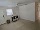 View of the living room featuring a ceiling fan, window with blinds, and simple decor at 1130 E Bay St, Winter Garden, FL 34787