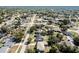 Wide aerial shot showcasing the layout of the neighborhood with mature trees and varied home styles at 1183 Feather Dr, Deltona, FL 32725