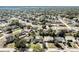 High-angle aerial view of neighborhood showcasing tree-lined streets, varying houses, landscaping and roads at 1183 Feather Dr, Deltona, FL 32725