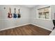 Room with hardwood floors, guitars hanging on the wall, and a large window at 1183 Feather Dr, Deltona, FL 32725