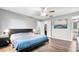 Spacious bedroom with wood-look floors, a modern bed frame, closet and stylish decor at 1183 Feather Dr, Deltona, FL 32725