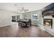 An open dining room area featuring a fireplace, TV, and access to the screened porch at 1183 Feather Dr, Deltona, FL 32725