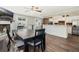 Open concept dining area with wood floors, a ceiling fan, and brick accents around the kitchen bar at 1183 Feather Dr, Deltona, FL 32725