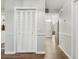 Hallway featuring wood-look flooring, closet, leading to other rooms in the home at 1183 Feather Dr, Deltona, FL 32725