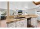 View of a kitchen area with travertine countertops and stainless steel dishwasher at 1183 Feather Dr, Deltona, FL 32725