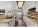 Kitchen view showcases white cabinetry and brick backsplash with stainless steel sink and modern appliances at 1183 Feather Dr, Deltona, FL 32725