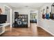 Inviting living area features wood-look floors and a large shelving unit, adding functionality and charm to the space at 1183 Feather Dr, Deltona, FL 32725