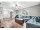 Cozy living room with a comfortable blue sofa, a large window, and wood-look flooring at 1183 Feather Dr, Deltona, FL 32725