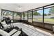 Bright sunroom featuring tile flooring, ceiling fan, black metal screens, and view of the fenced backyard at 1183 Feather Dr, Deltona, FL 32725