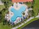 Aerial view of community pool, showcasing an inviting clover shape, surrounded by chairs and lush landscaping at 11846 Nautica Dr, Orlando, FL 32827