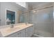 Bathroom featuring double sinks, a shower and lots of light at 11846 Nautica Dr, Orlando, FL 32827