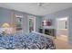 Bedroom with bed, bathroom access, ceiling fan and natural light at 11846 Nautica Dr, Orlando, FL 32827