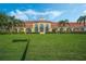 Stunning clubhouse featuring a red tile roof, large windows, and lush landscaping at 11846 Nautica Dr, Orlando, FL 32827